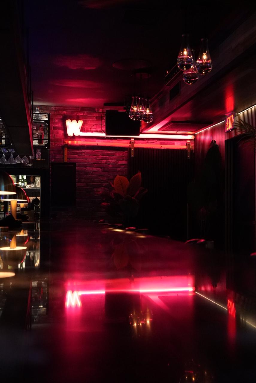 The bar glowing in pink neon